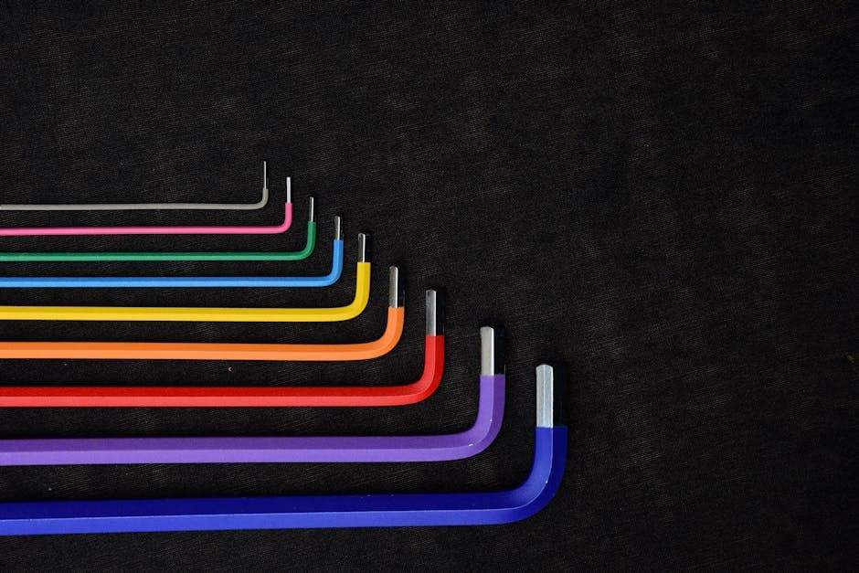 Set of colorful L-shaped hex keys displayed in a row on a dark textured background.